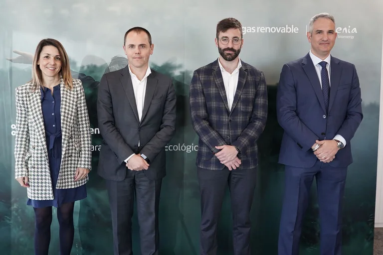 Four professionals taking a group photo after the agreement