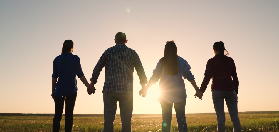 People holding hands in the field