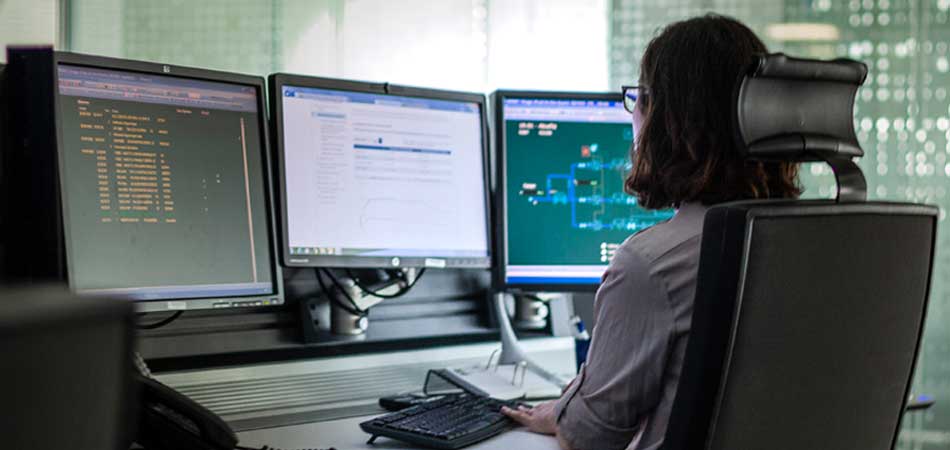 Woman working with three computers