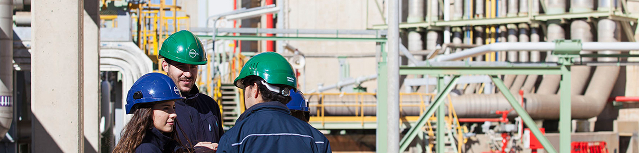 Three workers talking at work