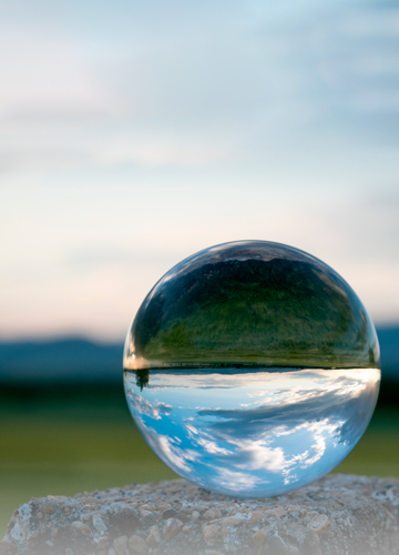 Drop of water reflecting a landscape