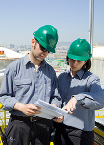 Operators working with reports in a plant